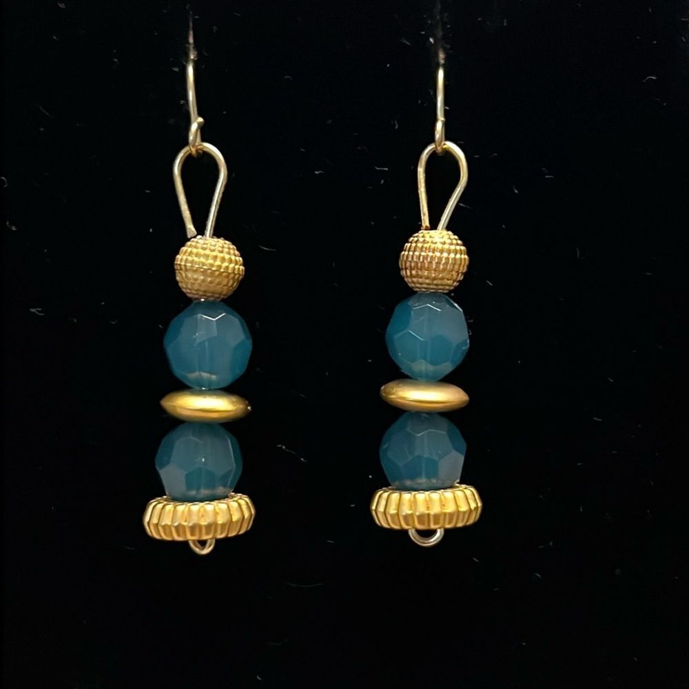 Handcrafted gold tone earrings with green and vintage gold beading.